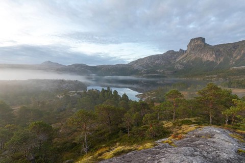 Magical morning fog on Steigtindvatnet in front of the majestic Steigtinden in Norway near Bodø