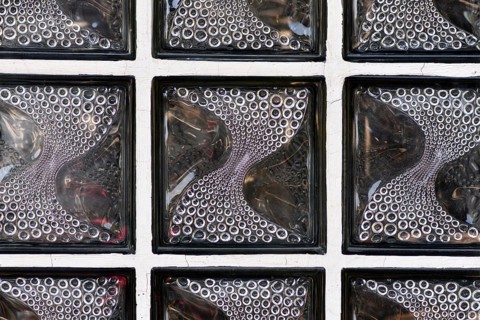 Textured translucent glass block wall with curved circular pattern