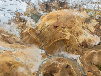 Steaming hot springs and colourful rhyolite mountains, aerial view, Hveradalir geothermal area,