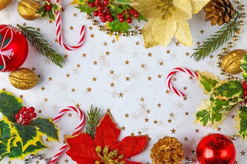 Frame made of Christmas decorations, such as fir branches, baubles, nuts on a white background with