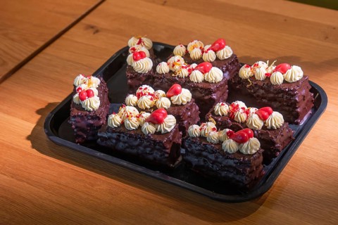 Chocolate chips with cream and cherries served on a tray, Café Kuh, Deckenpfronn, Germany