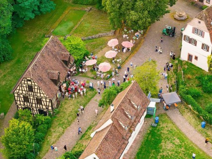 Village square with people and half-timbered houses at a summer party, Calwer Klostersommer