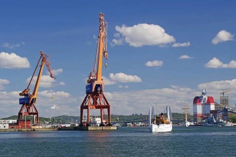 Industrial harbor landscape with cranes and ships under a clear sky, Eriksberg, Gothenburg, Sweden