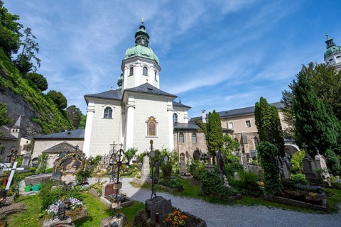 Graves at St. Peter Cemetery with St. Peter Collegiate Church, Old Town, Salzburg, Austria