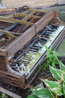Detroit, Michigan - A grand piano, left to decay outside a residence