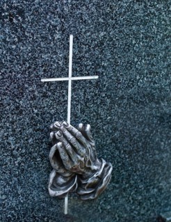 A tombstone in a cemetery. Praying hands by Albrecht Dürer, Ruehstätte, Bremen, Lower Saxony,