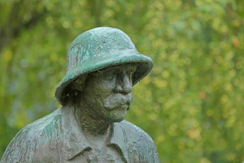 Monument and sculpture of Albert Schweitzer by Gerhard Geyer, head of man with beard and hat,