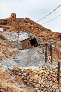 Abandoned mining site with rocky trails and abandoned buildings in a dry environment, The silver