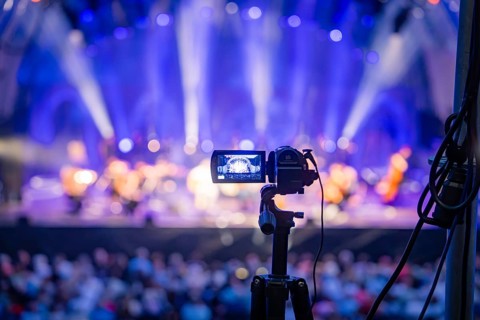 Camera on stand films a brightly lit concert stage, Calwer Klostersommer Festival, Hirsau Abbey,