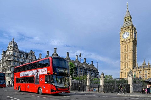 Red double-decker bus in front of Elizabeth Tower with Big Ben, clock tower, Houses of Parliament,