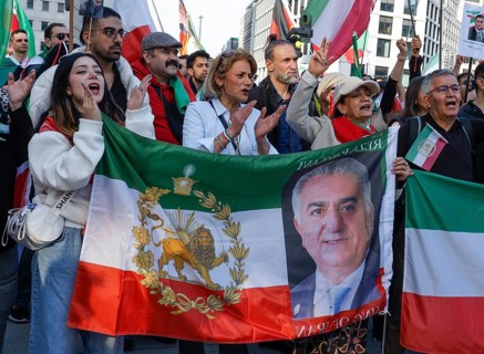 Iranians demonstrate with a poster of Prince Reza Pahlavi on the day of the US and Israeli attack