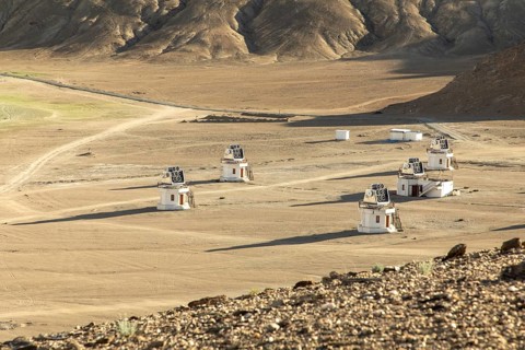 A series of small observatory structures dot the isolated, vast arid plains of Ladakh, India, under