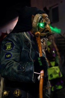 Person with green illuminated carnival mask in mysterious atmosphere, carnival, Schellbronn night