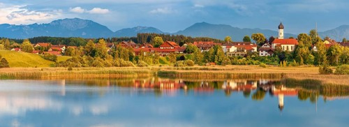 View over the Sengsee lake to Iffeldorf with St. Vitus church in autumn, Osterseen, Fünfseenland,