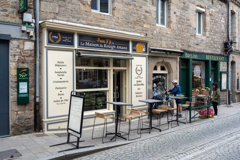 Historic natural stone architecture with La Maison du Kouign Amann and Restaurant Bara Inn,