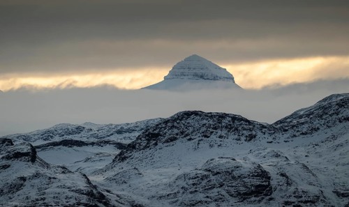 One of the three Tee Kroner (Three Crowns) mountains, partly shrouded in cloud, Kongsfjord or
