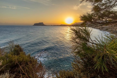 Stunning sunset over the Mediterranean Sea along Costa Blanca, capturing vibrant colors and serene