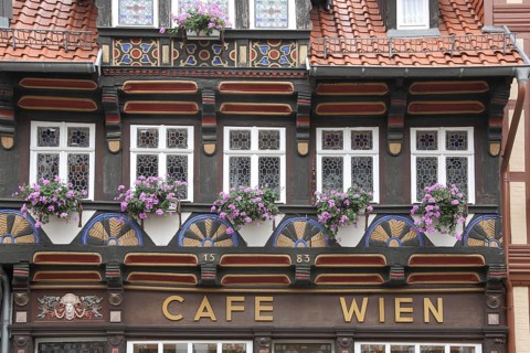 Historic house façade with floral decoration and ornaments from Cafe Wien built in 1583, dark brown