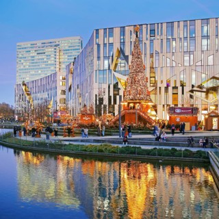 Dreischeibenhaus and Christmas market in front of the Koe-Bogen by architect Daniel Libeskind,