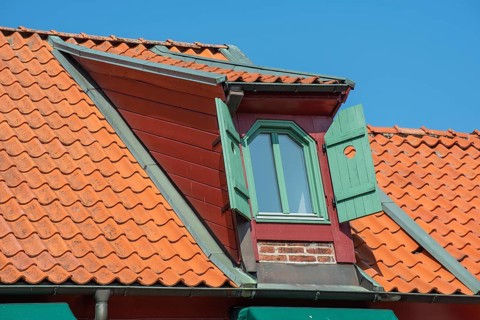 Cup with windows and magazine hatches on the roof of an old house in Ystad, Skåne County, Sweden,