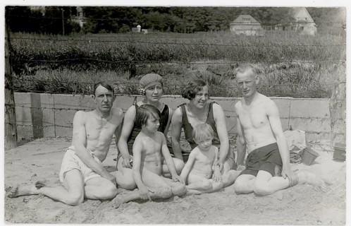 Bathing, swimwear, woman, men, children, leisure, fun, summer, family with two children sitting in