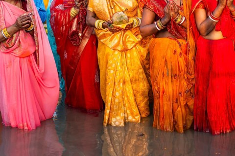 Hindu devotees gather on the banks of the Brahmaputra River to offer prayers to the Sun God on the