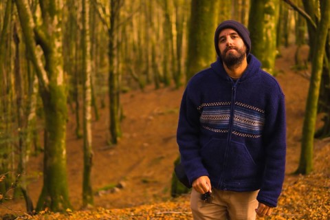 Lifestyle, a young man in a blue wool sweater enjoying the forest in autumn. Artikutza Forest in