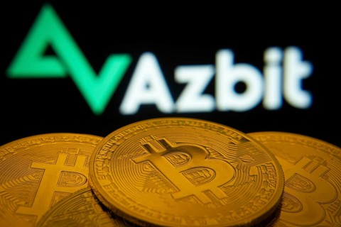 Dhaka, Bangladesh- 02 June 2025: Close-up of Bitcoin coins with the Azbit logo visible on a screen