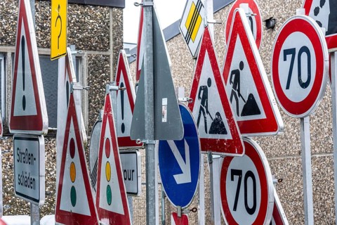 Storage for traffic signs in the yard of a road maintenance department, various signs with