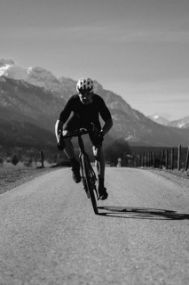 Road bike rider in spring near Halblech in the Allgäu in front of a picturesque backdrop of the