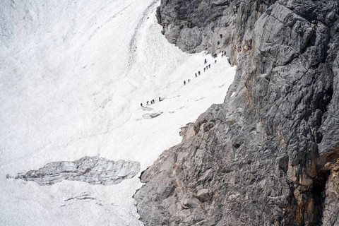 Mountaineers queuing at the transition from the Höllentalferner to the Zugspitz via ferrata, on a