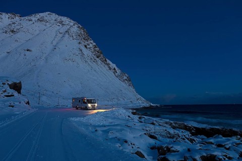 Motorhome in winter on pitch, Storsandnes Beach, Myrland, Lofoten, Norway