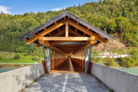Wooden bridge over a river, surrounded by forests and mountains, in sunny weather, Innsteg, bridge