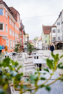 Street café with empty tables and half-timbered houses in an idyllic city scenario, Isny, Allgäu,
