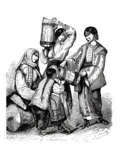 Women and children in traditional Wallachian and Gypsy clothing. On display is a group of woman and