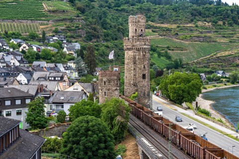Freight train, in the Upper Middle Rhine Valley, runs directly in front of the residential