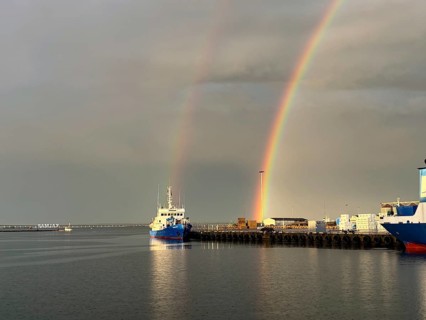 Harbour with ship and double rainbow in the sky over calm water, Kalmar, Kalmar Län, Sweden