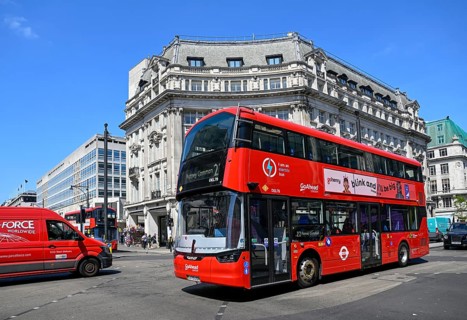 Red double-decker bus at Oxford Circus at the intersection of Oxford Street and Regent Street, City