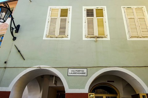 House façade with alleyway sign VIA PORTICI LAUBENGASSE in Laubengasse in the historic old town of