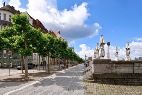 Düsseldorf, Germany - June 9th 2026: Beautiful riverside promenade 'Rheinuferpromenade' with trees