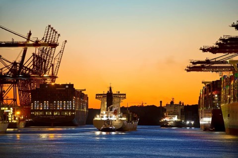 Container ships at the Eurogate container terminal in the evening with an atmospheric sunset,