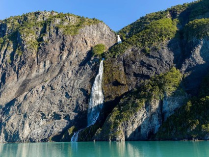 Waterfall at the Bay of Last Hope, fjords and mountains, Puerto Natales, Patagonia, Chile