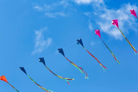 Strung kites flying in the sky, garland, cirrus, kite festival in Vinsebeck, Steinheim, Eggegebirge