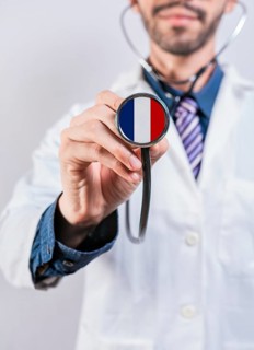 France health and medical insurance concept. French Healthcare System, doctor holding stethoscope