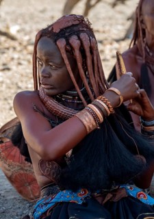 Himba woman combing her hair, near Opuwo, Kaokoveld, Kunene, Namibia