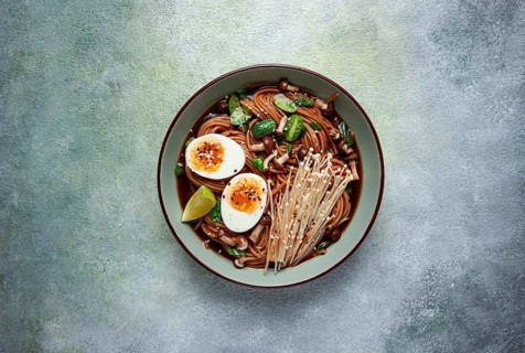 Soba, buckwheat noodles, with enoki mushrooms, shimeji and boiled egg, top view, homemade, no