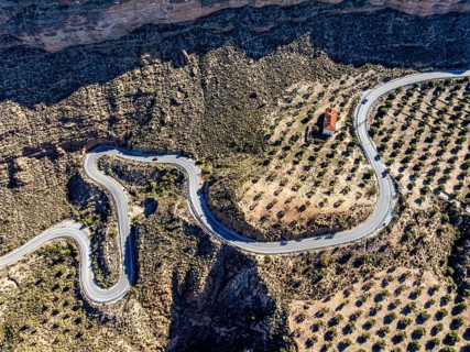 Deep canyon at the Gorafe desert, winding road to village Gorafe, aerial view, Gorafe Desert,