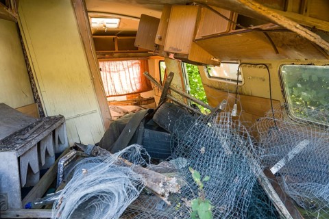 Parked rotten trailer, abandoned caravan on a pasture, Germany