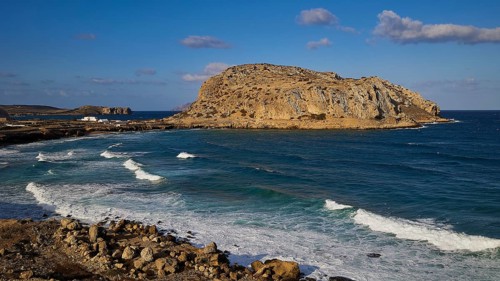 Rocky coast and clear blue sea under a sunny sky, Acropolis Hill, Arkasa, West Coast, Karpathos,