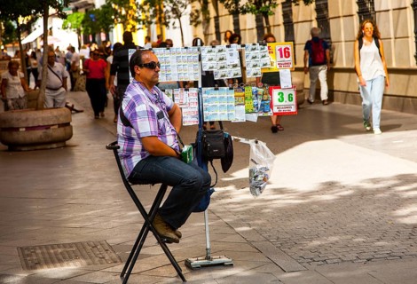 Lottery ticket seller in Velazquez street a busy shopping in central Seville, Spain